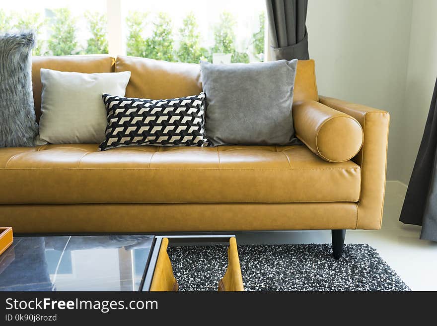 Modern decorative pillow on brown leather sofa in living room. Modern decorative pillow on brown leather sofa in living room