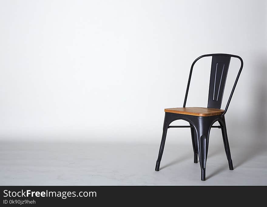 Steel with wood chair on Grey textured background wall Copy space