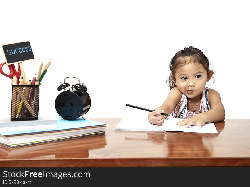 Asian little girl writing doing homework early childhood education, back go to school. Asian little girl writing doing homework early childhood education, back go to school