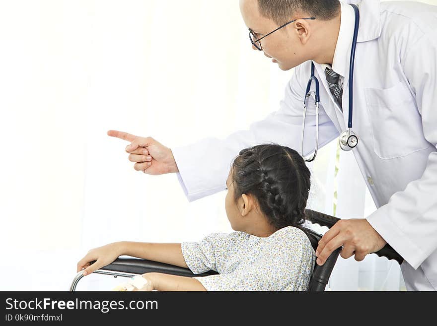 Male asian doctor touching pediatric patients and smiles at hospital, Concept care