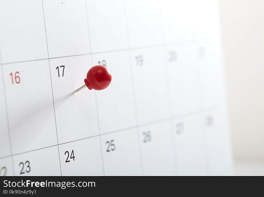 A red pin on calendar to remind about the appointment, Tax Day 2018 takes place on April 17, 2018