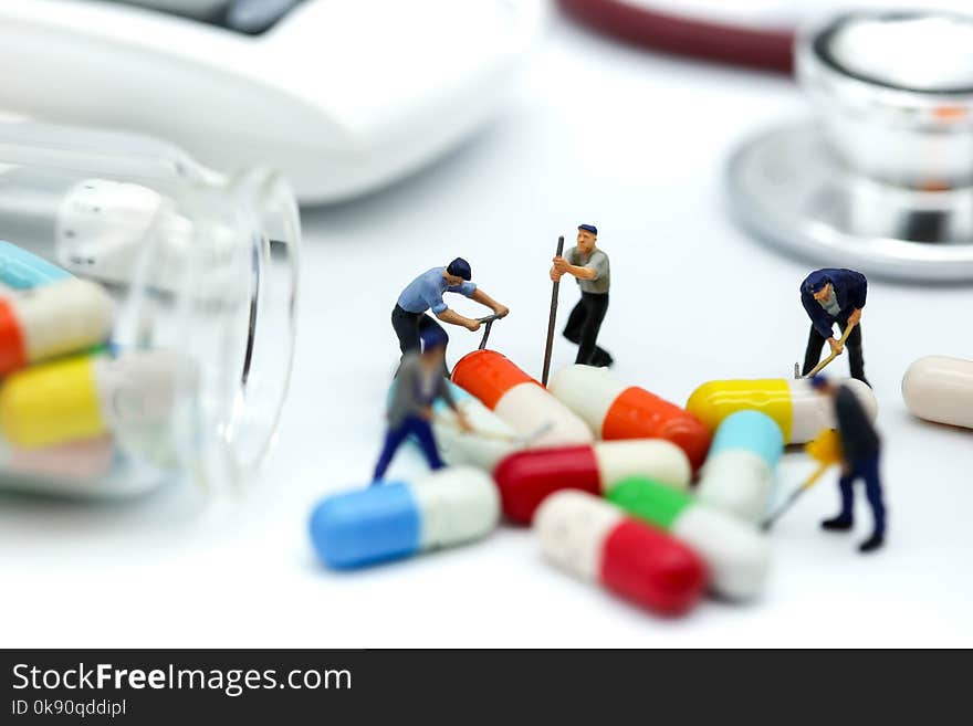 Miniature people: worker team with stethoscope and syringe and g