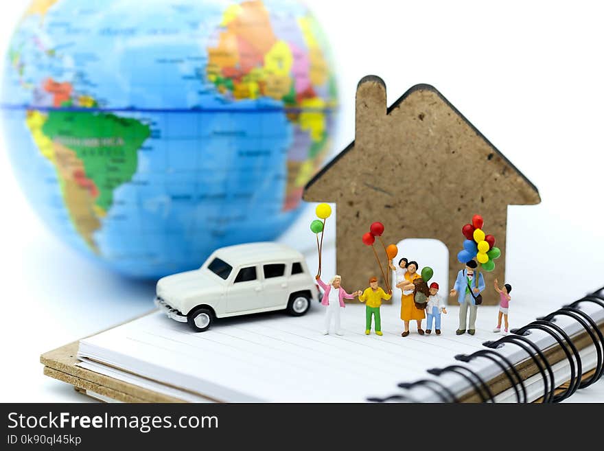 Miniature people : family and children with colorful ballons standing of mini house and car with world map background,International Day of Families