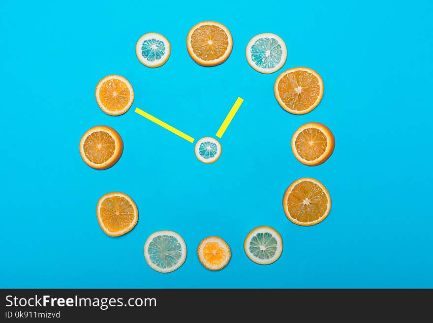 Clock, citrus fruit instead of bars and arrow in the middle. Clock, citrus fruit instead of bars and arrow in the middle