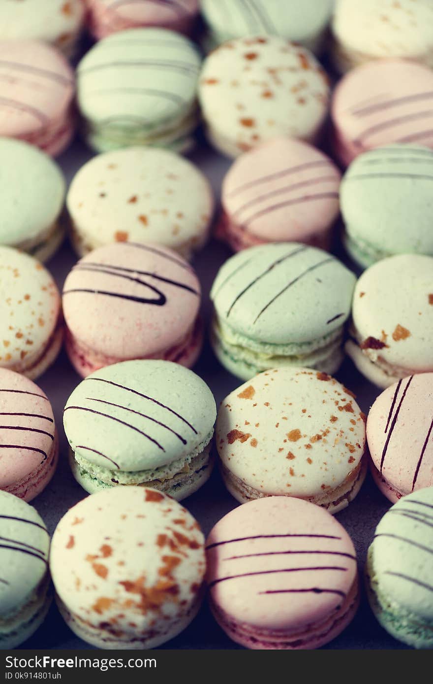 Colorful french macaroons flat lay. Pastel colors pink, green, yellow macarons with copy space, top view. Holidays and