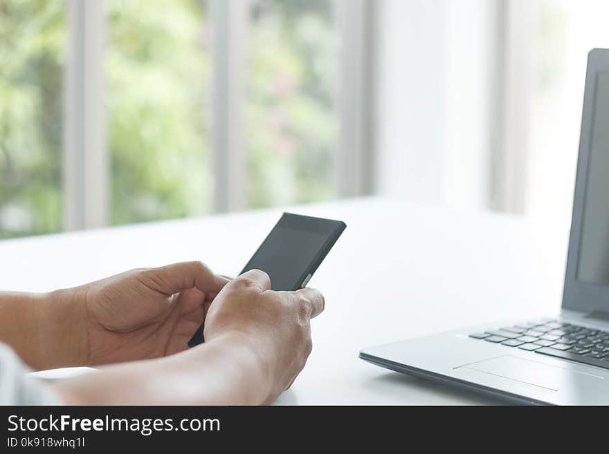 Businessman use smartphone on white table for communication concept