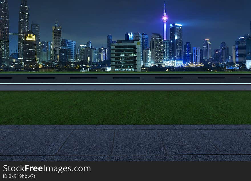 Side angle view empty asphalt road with grass ,stone marble floor and city skyline background . Mixed media .