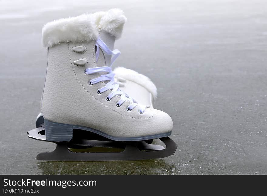 Pair of skates for figure skating on ice rink. Pair of skates for figure skating on ice rink.