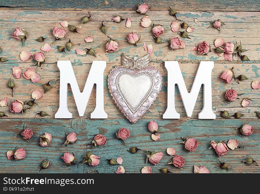 Mothers day background with letters and small pink roses on old wooden table. Happy mother`s day concept.