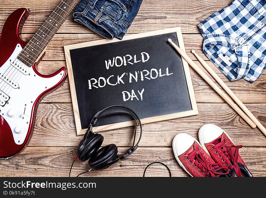 World Rock`n`Roll Day background with blackboard, music equipmen