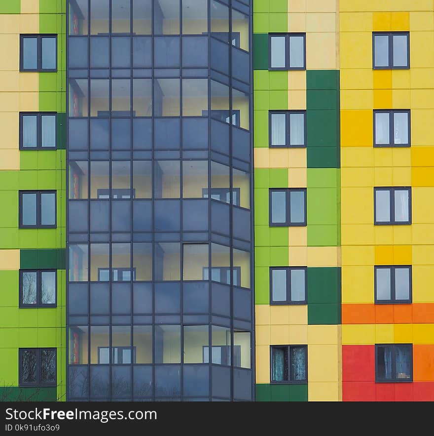 Modern beautiful new buildings. Colored wall on the background of blue sky.