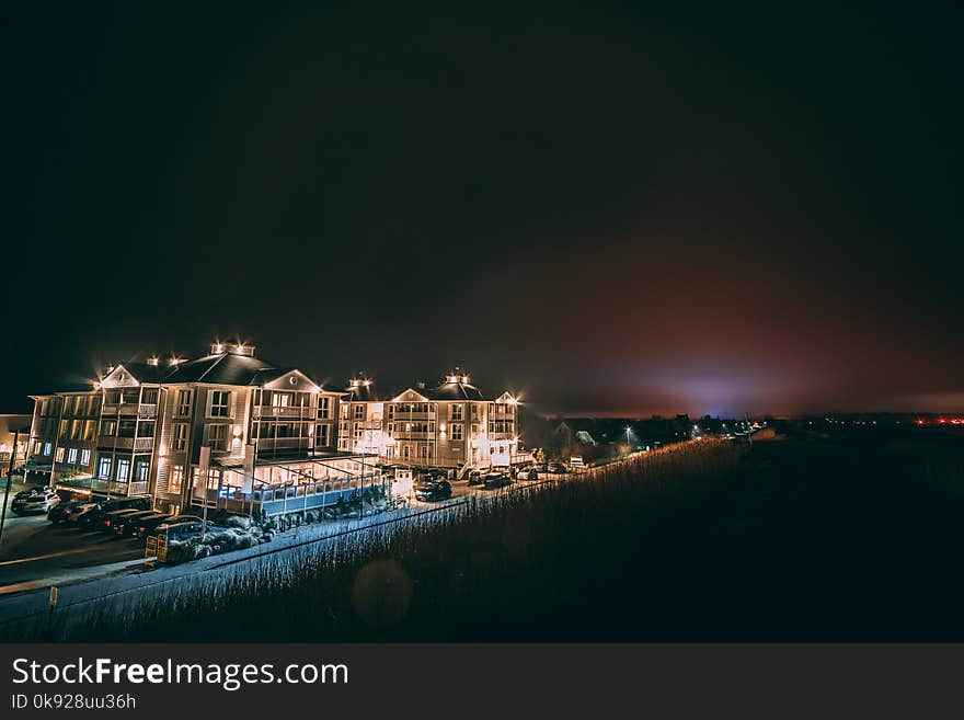 White Concrete Building Beside Body of Water during Nighttime