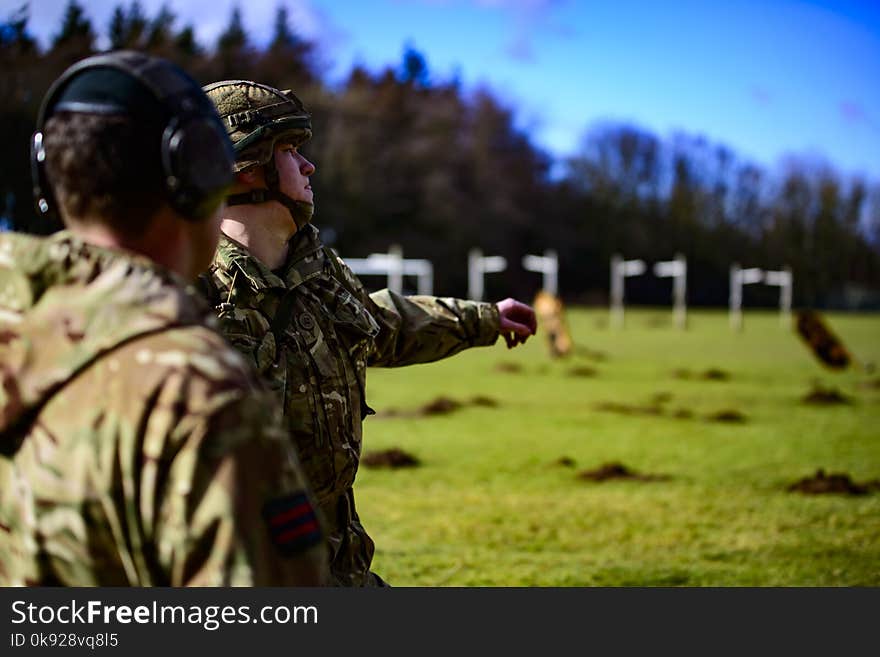 Selective Focus Photo of a Soldier on Green Grass Field