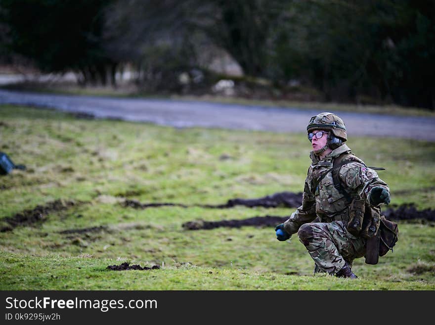 Man on Squat Position Standing on Grass