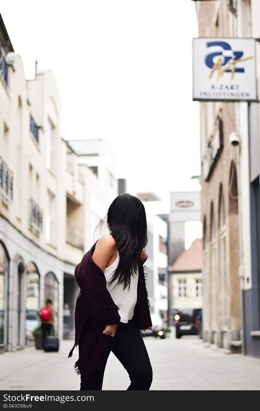 Woman Wearing White Tank Top With Maroon Jacket Crossing N Street