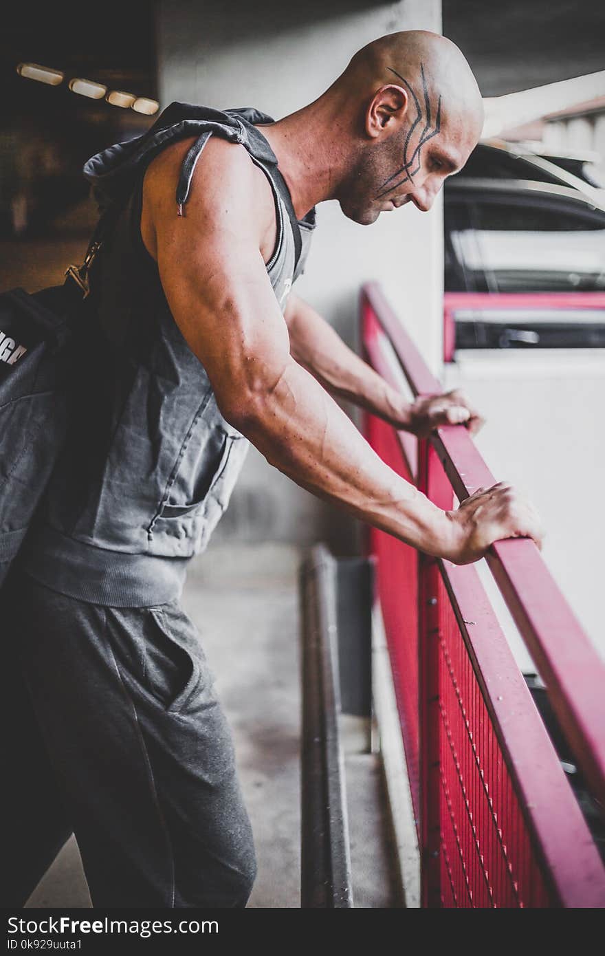 Man in Gray Sleeveless Top and Black Sweat Pants