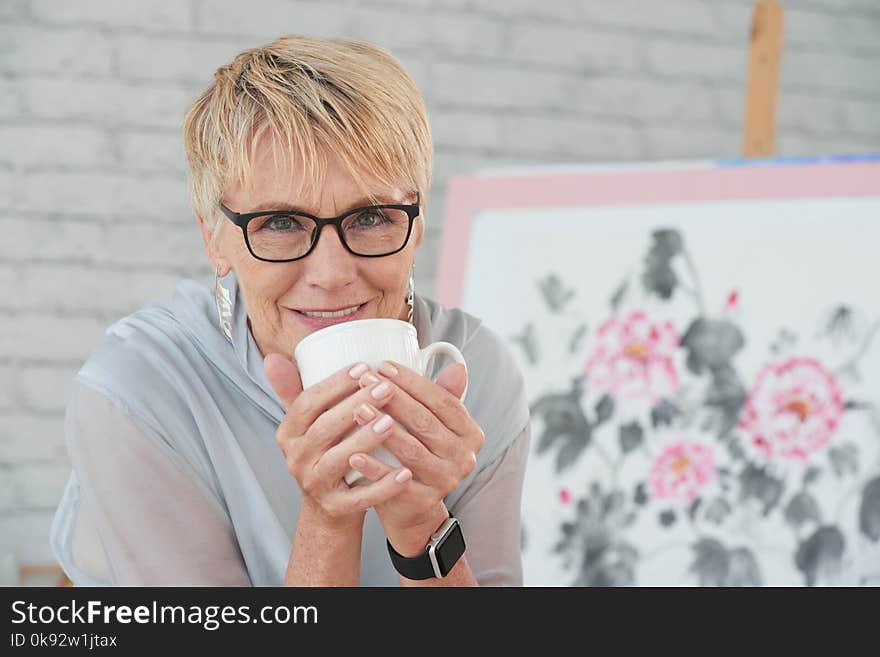 Cheerful senior woman enjoying cup of fresh coffee. Cheerful senior woman enjoying cup of fresh coffee