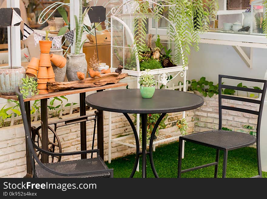 Table iron chair in the backyard grass. At home.