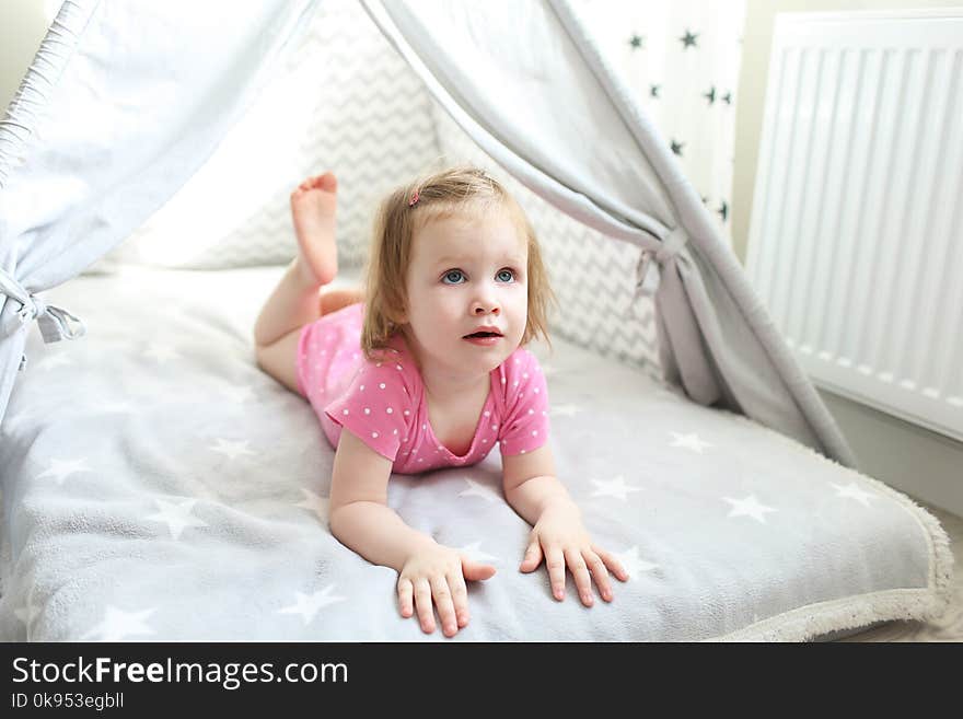 2 years little girl in wigwam tent bed at home