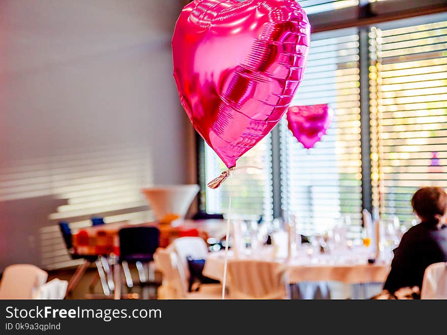 Pink Festive Balloons Shape Of Heart With The Party Guests In The Background