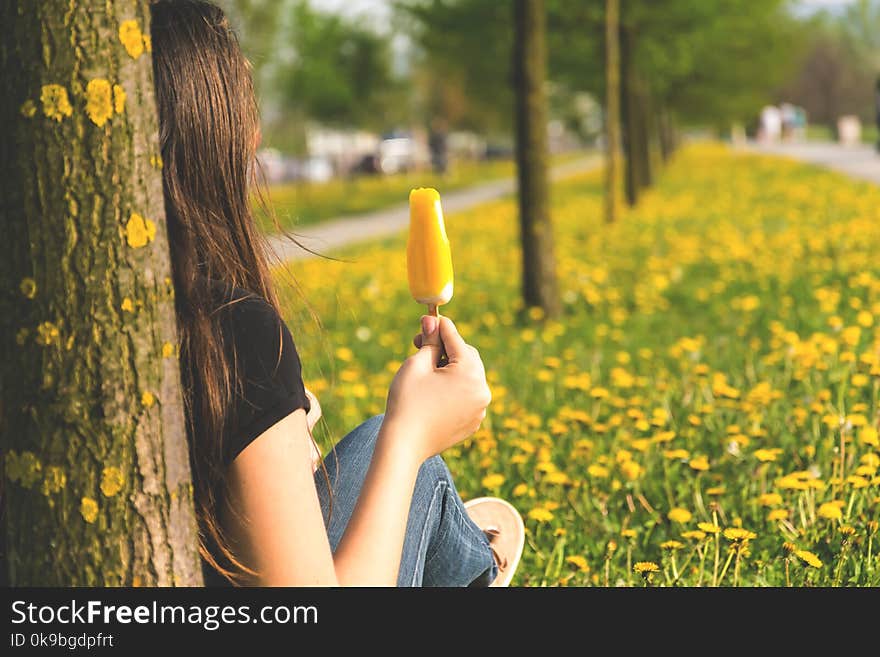 Girl eating ice cream and enjoying the nature and spring.