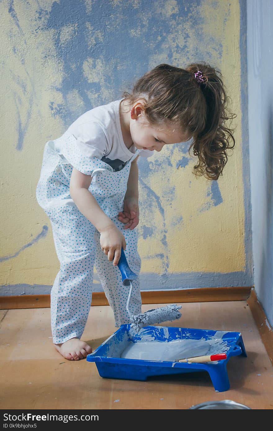 Little kid girl making renovation at her room.