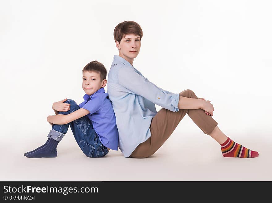 Mother`s Day concept: Happy smiling mother and son looking to camera isolated on on white studio background. Happy family concept. The faces of mother and son close up. Human emotions concept