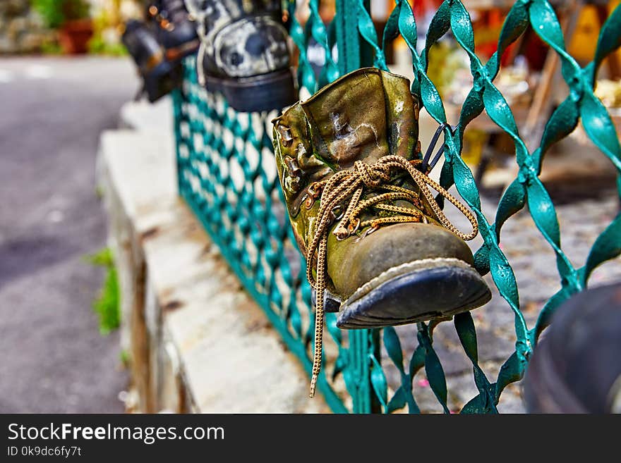 Old Battered Boot With Lace On Fence