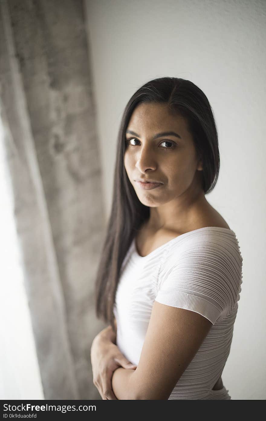 Photo of a very attractive young woman with beautiful dark hair, sikin, and eyes, wearing a white dress. Photo of a very attractive young woman with beautiful dark hair, sikin, and eyes, wearing a white dress.