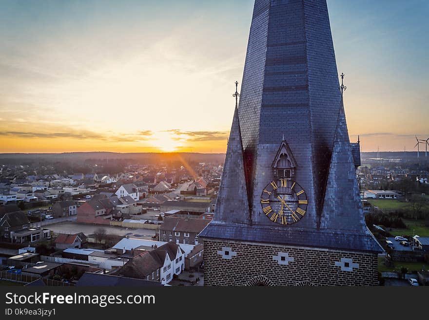 Drone shot close up of a church tower clock at golden hour. Drone shot close up of a church tower clock at golden hour