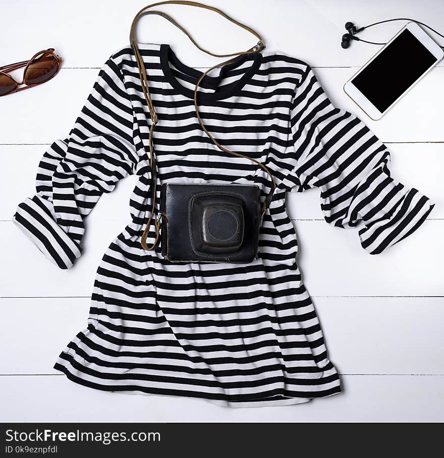 White cotton shirt in black stripes and an old vintage camera