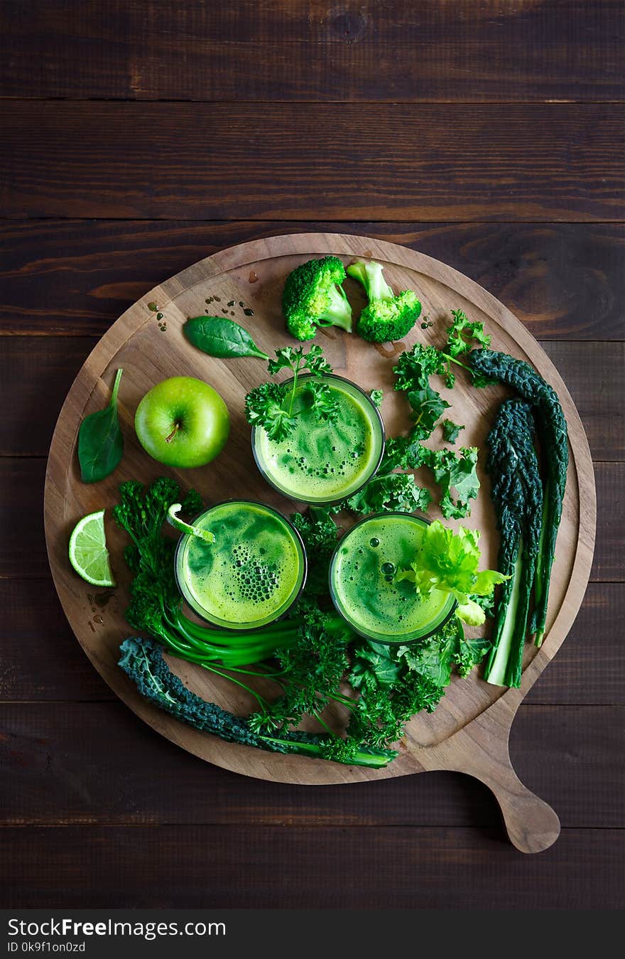 Fresh Organic Green Juice Shot from Overhead on a Round Board with Ingredients. Fresh Organic Green Juice Shot from Overhead on a Round Board with Ingredients