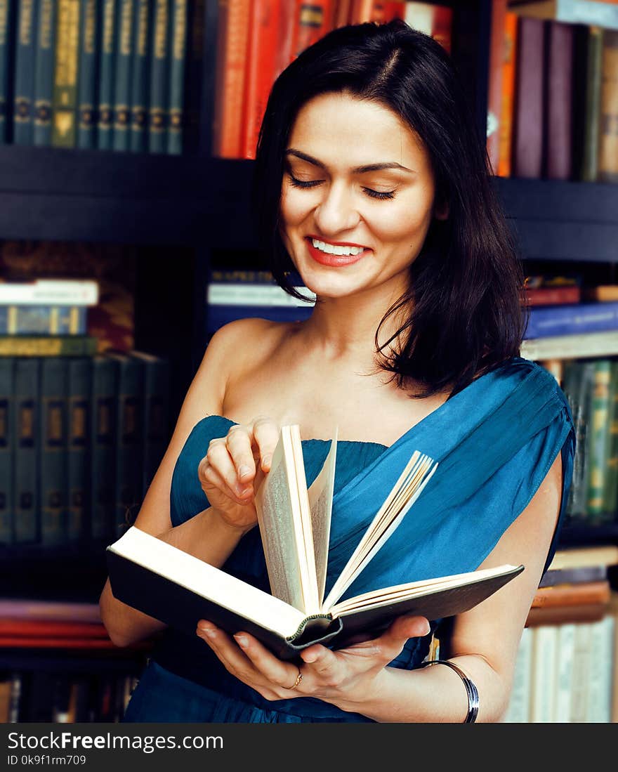 Portrait of beauty young woman reading book in library smiling, lifestyle real rich people concept education close up