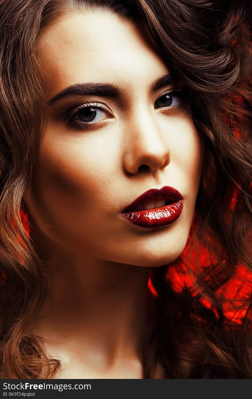 Beauty Woman with Perfect Makeup Beautiful Professional Holiday Make-up. Red Lips and Nails Beauty Girls Face isolated on Black background Glamorous Woman