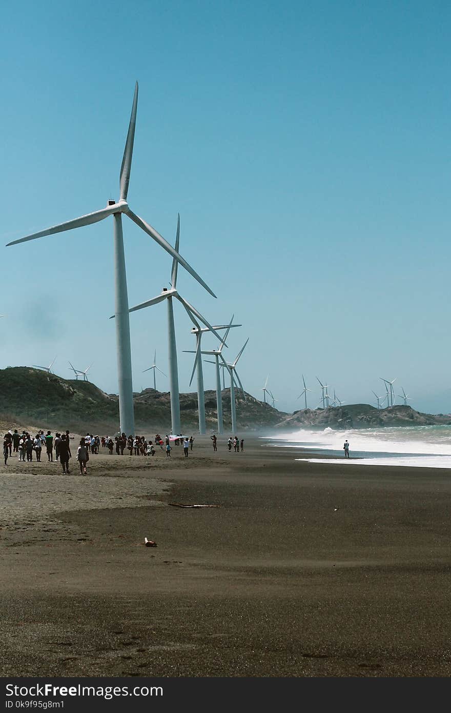 Wind Mills Near the Body of Water