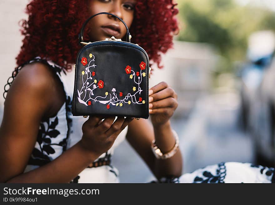 Woman Holding Black Leather Handbag