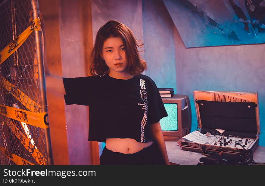 Woman Wearing Crop Top Standing Near Wire Fence