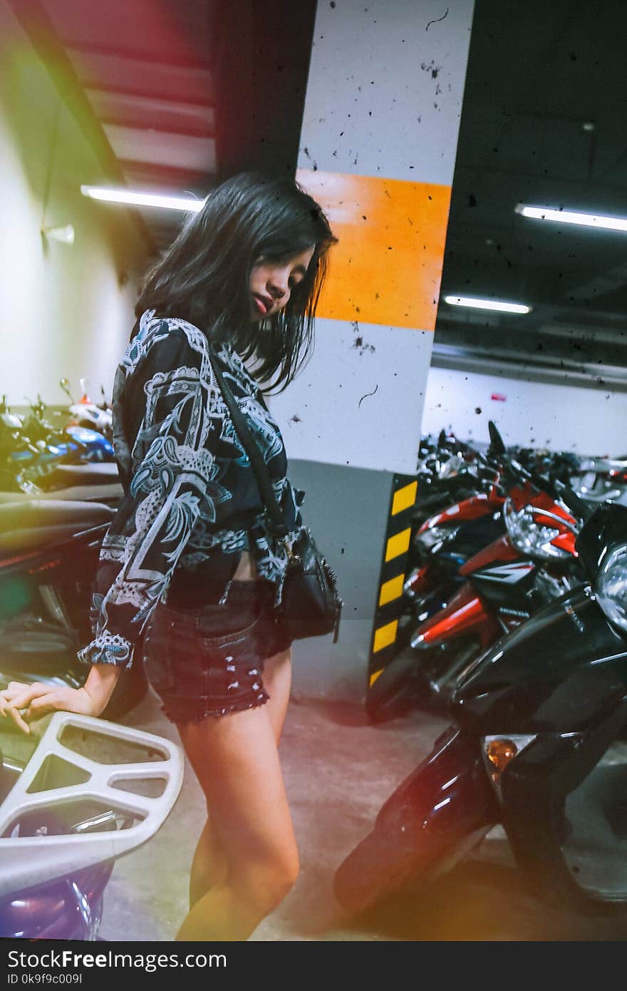 Photography of a Woman Near Motorcycles