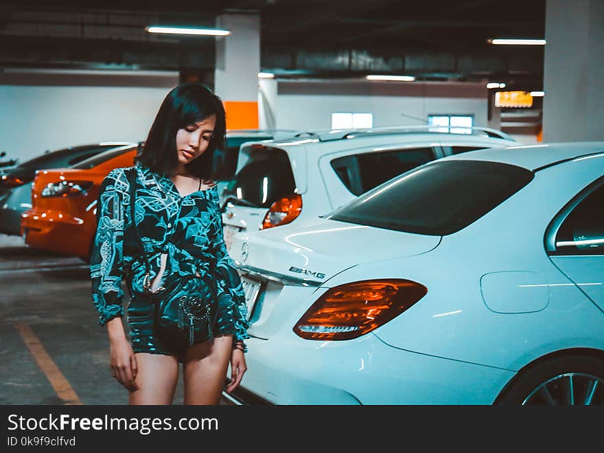 Woman Wearing Blue Printed Romper Standing Beside Car