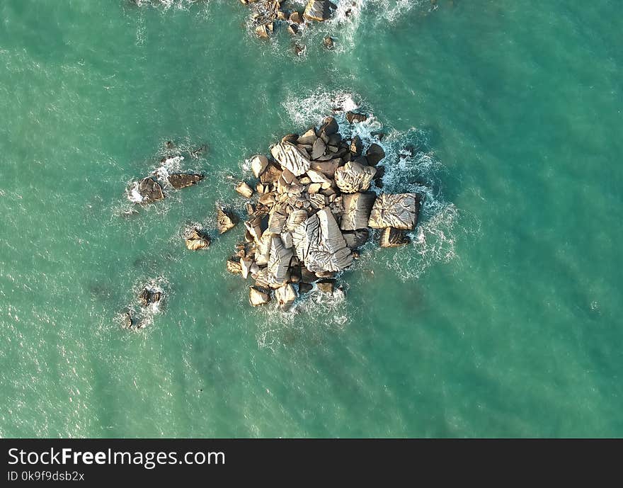 Top View of Rock Formations Surrounded by Water