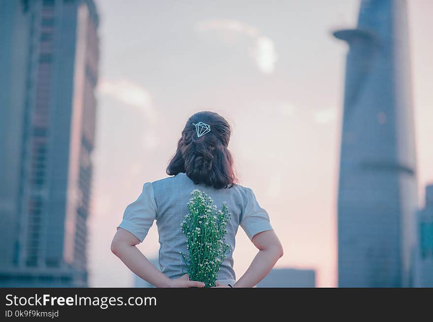 Photography of Woman Holding White Flowers