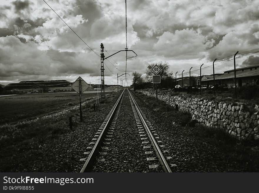 Grayscale Photograph of Train Rail