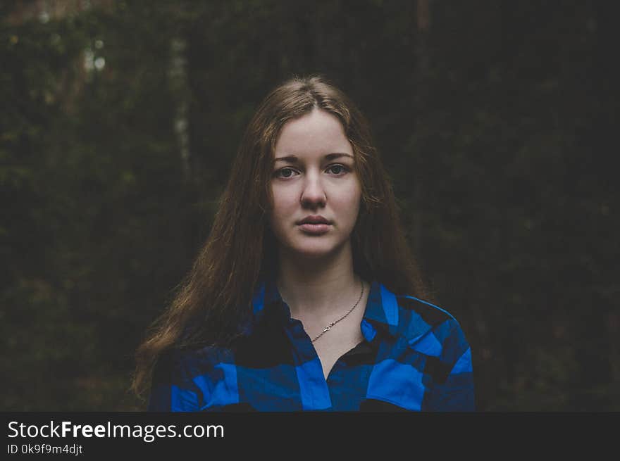 Woman in Blue and Black Plaid Button-up Shirt