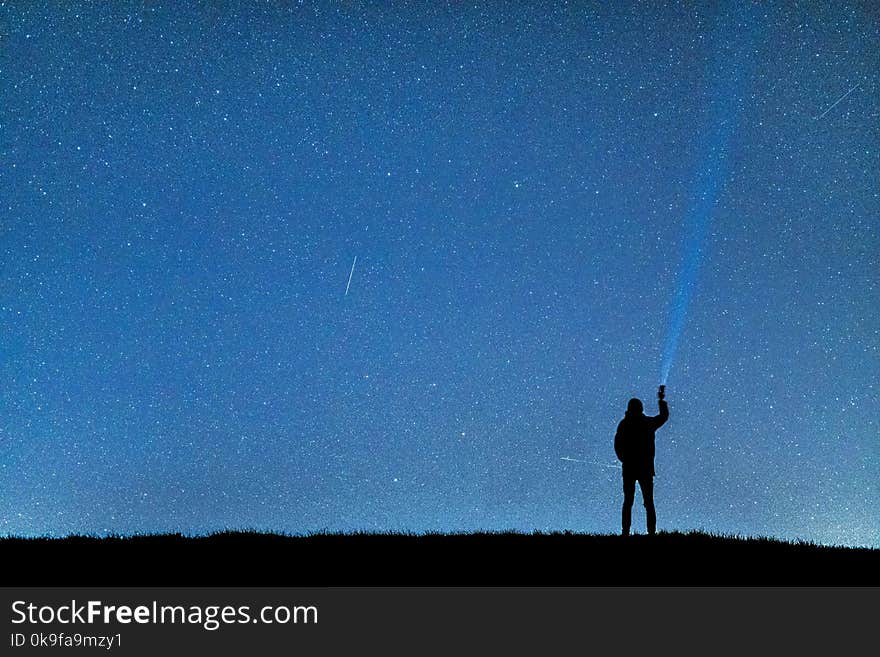 Silhouette Of Man Under Blue Sky During Nighttime