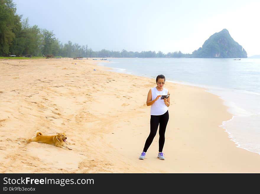 Woman relax morning with dog on beach