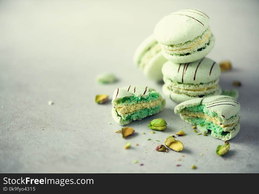 Green mint french macaroons with pistachios. Pastel colors macarons, copy space. Holidays and celebrations concept