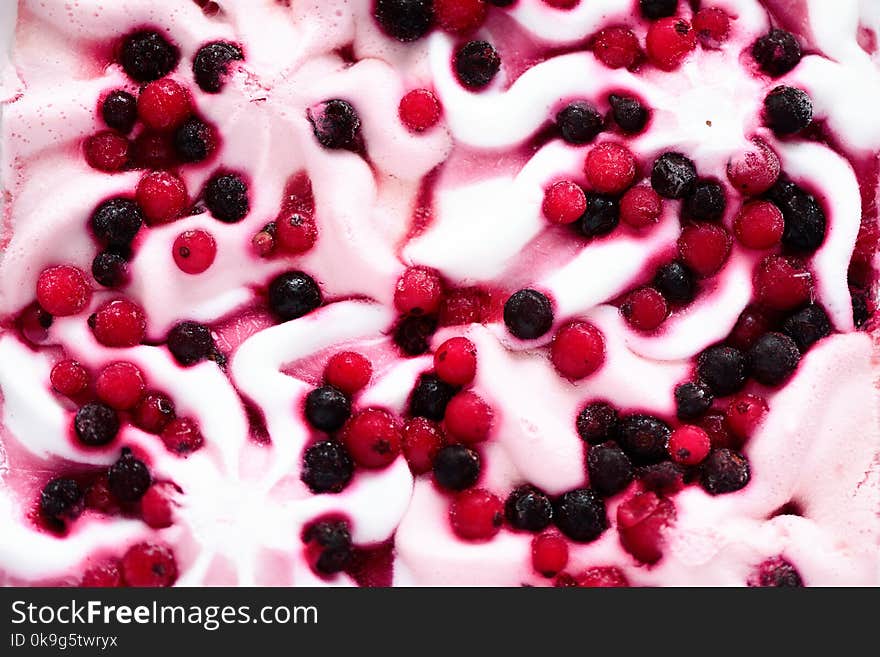 Pink ice cream with berries background. Cranberries in frozen ice-cream bowl texture. Copy space