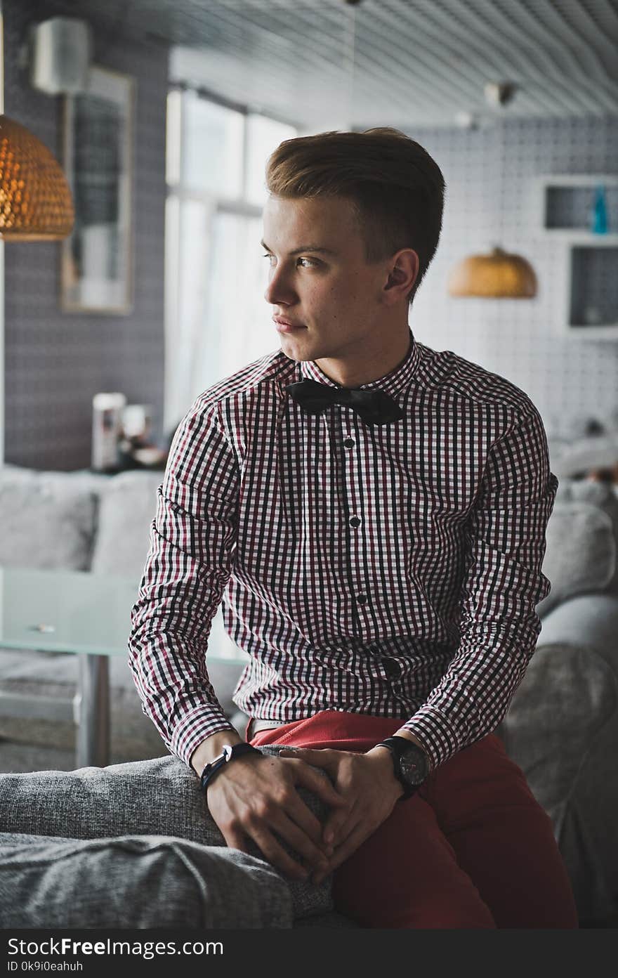 Portrait of a boy in a striped shirt and a bow tie in the cafe. Portrait of a boy in a striped shirt and a bow tie in the cafe.