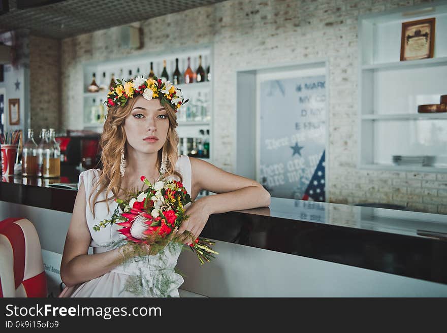 Beautiful girl with bouquet of flowers and a wreath of them. Beautiful girl with bouquet of flowers and a wreath of them.