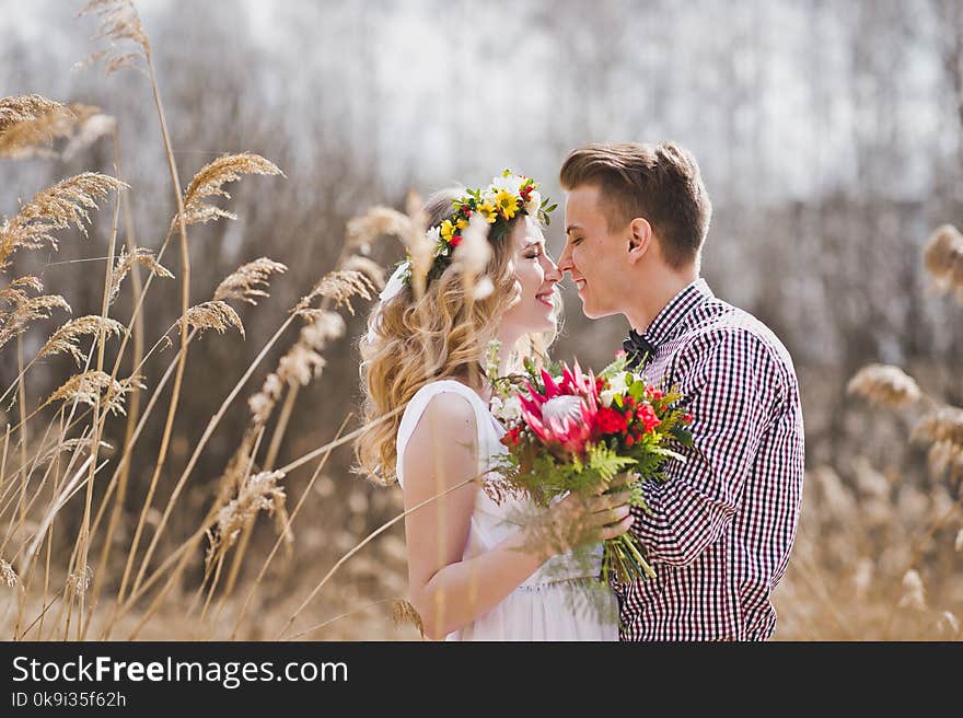 A Young Couple Tenderly Looking At Each Other Amid The Reeds 582